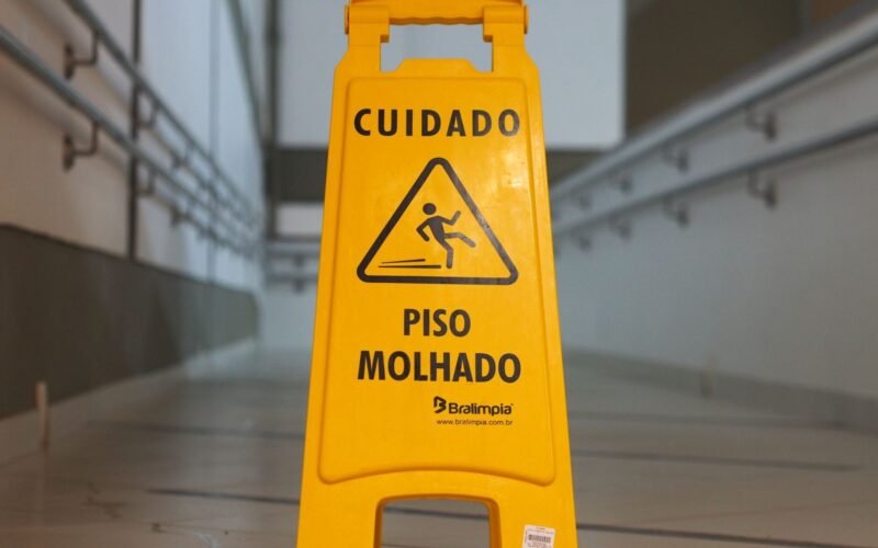 Wet floor caution sign in a commercial building corridor.