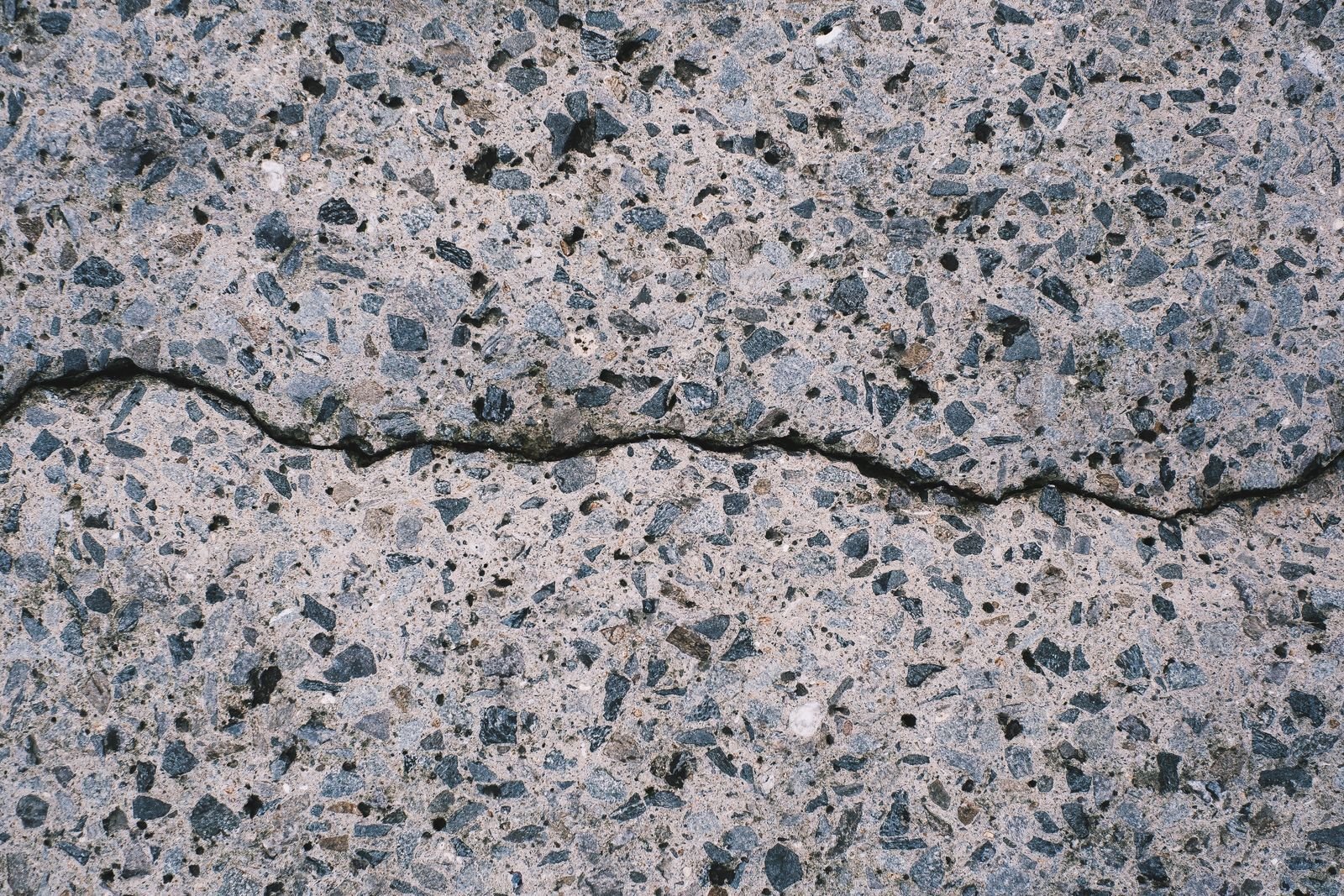 Cracked concrete slab foundation showing movement