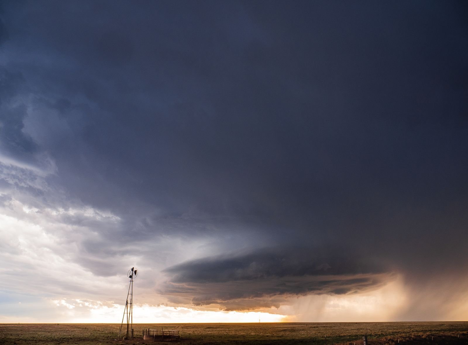 Dark storm clouds building over open Texas plains