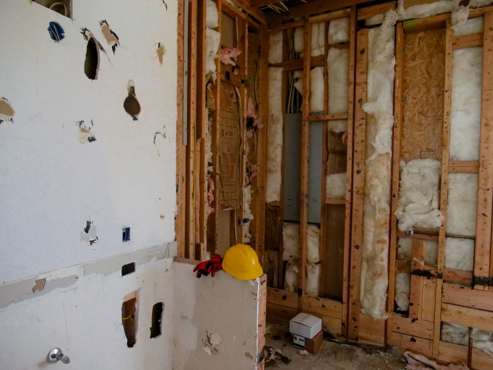 Wall opened with drywall removed to dry framing after firefighting water
