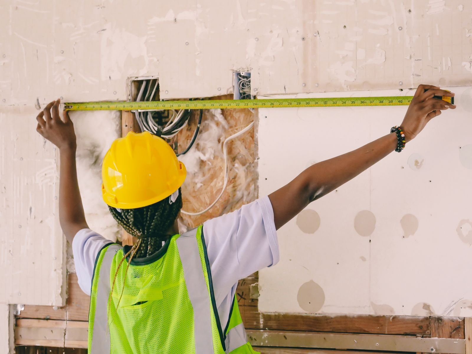 Technician inspecting a wet wall with a moisture meter